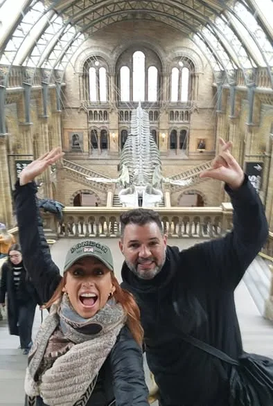 A cheerful couple poses for a selfie in front of the giant whale skeleton inside the Natural History Museum in London.