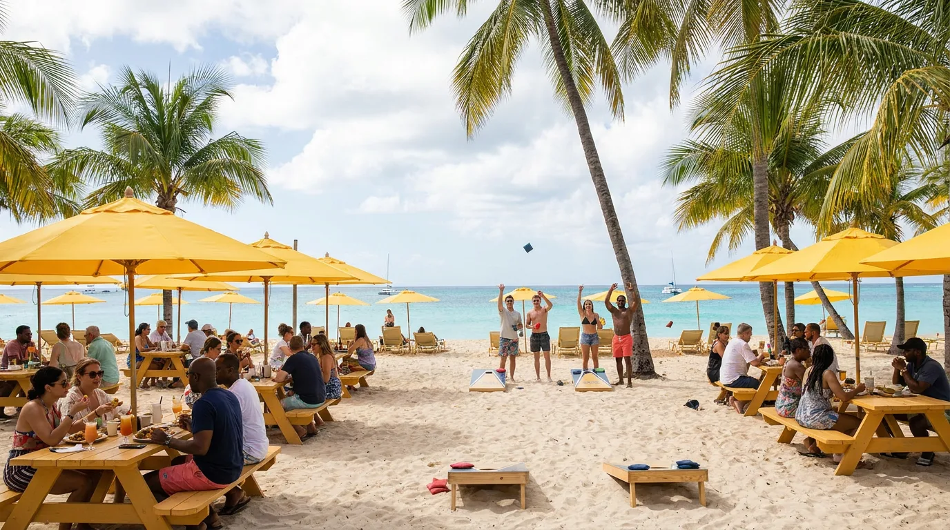 Guests dine at yellow picnic tables and play cornhole along a palm-lined beach in Anguilla.